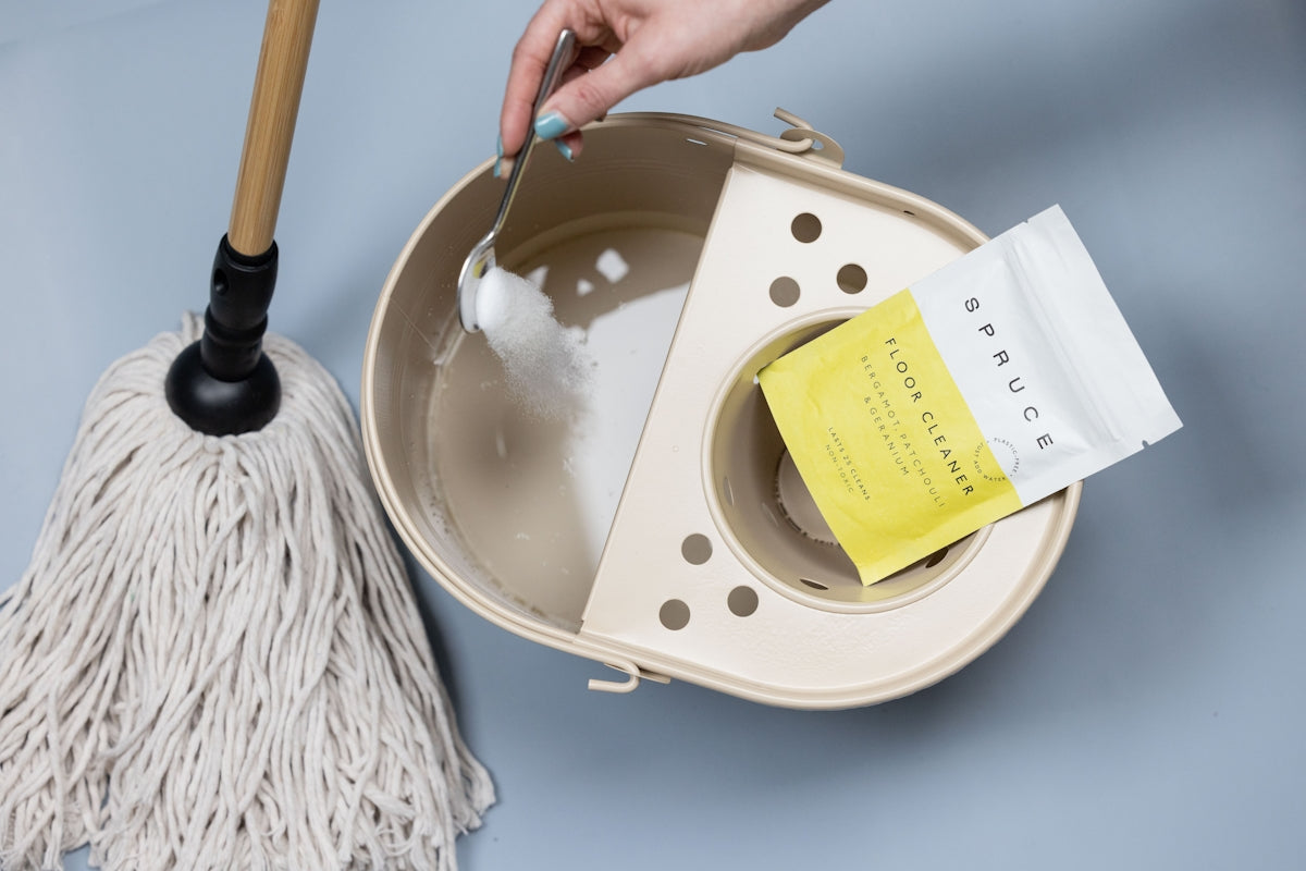 Adding cleaning powder to a mop bucket