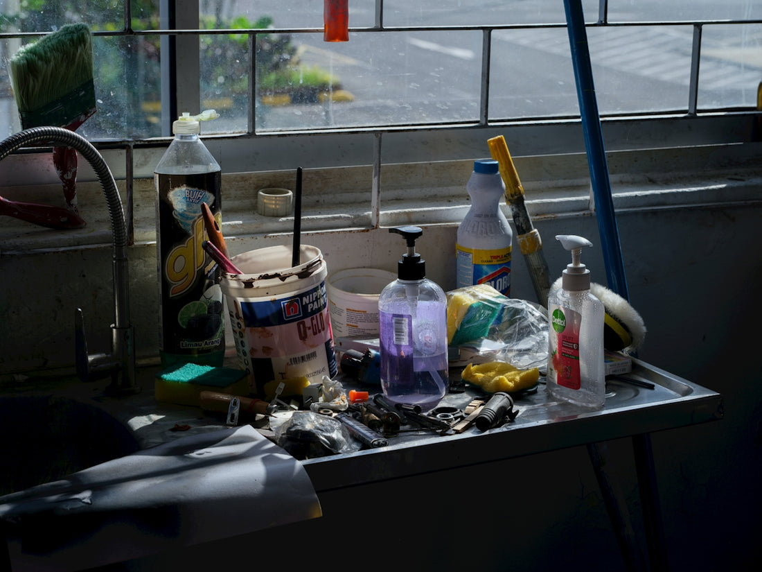 Various cleaning supplies and tools on a shelf