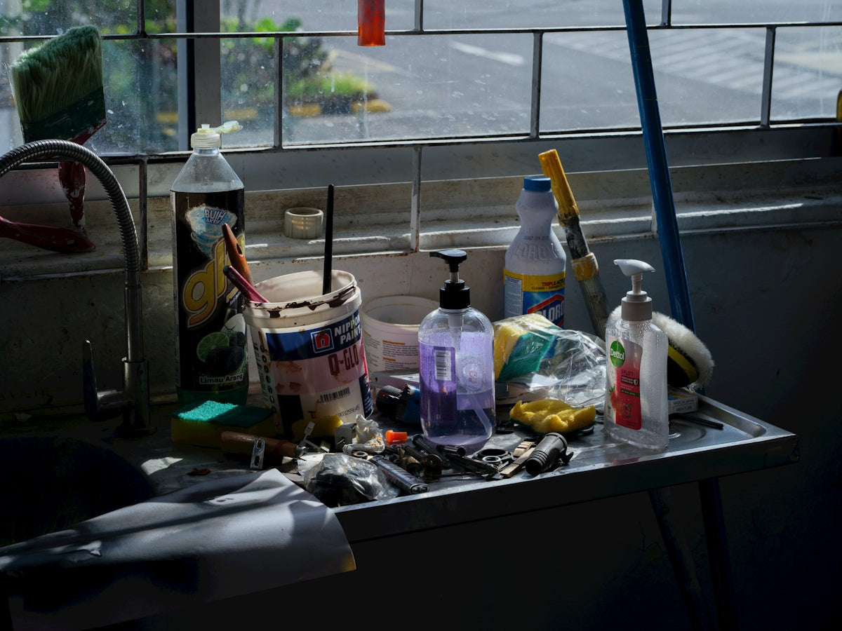 Various cleaning supplies and tools on a shelf
