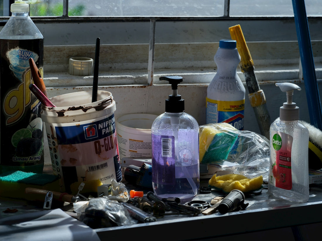 Assorted cleaning supplies and tools on a counter