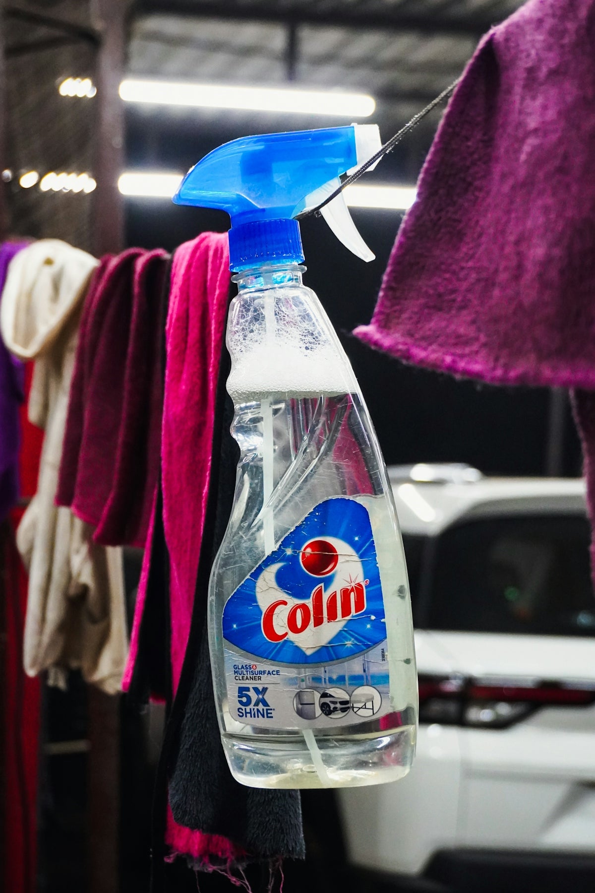 Spray bottle of cleaning liquid hanging with cloths