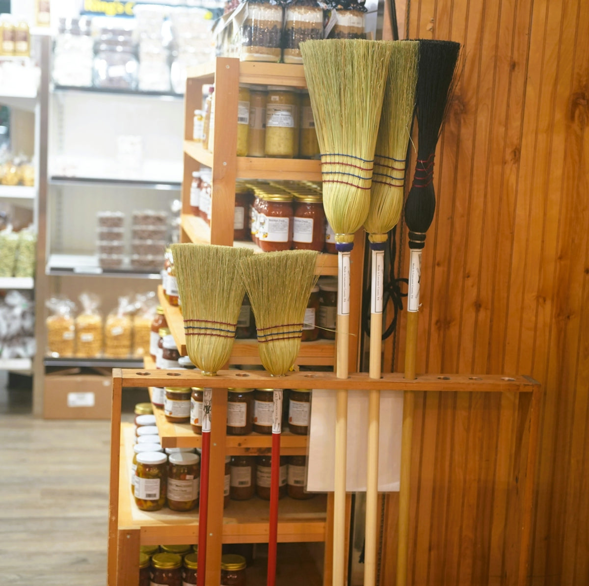 Brooms and cleaning supplies on shelves in a store